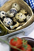 Quails' eggs and broken eggshell in small basket