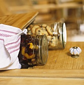 Cherry compote in preserving jar and biscits in storage jar