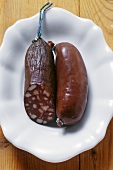 A black pudding & a Rotwurst ('red sausage') with a piece removed