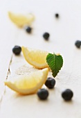 A display of lemon slices and fresh blueberries