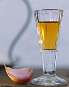 A glass of sherry and a clove of garlic