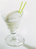 A glass of kefir with straws
