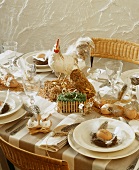 A festively laid Easter table with a chicken ornament