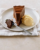A slice of chocolate truffle cake with vanilla ice cream