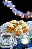Profiteroles with white chocolate and a cup of coffee