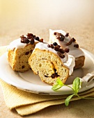 Three pieces of yeast dough cake with raisins and icing sugar