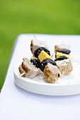 Pork kebabs with dried plums and cheese