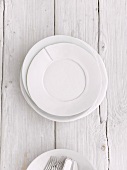 White plates on a wooden surface