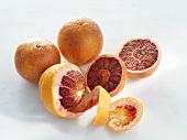 Blood oranges, whole and halved and spiral peel