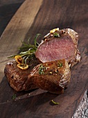 Roast saddle of lamb on a wooden board