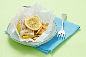 Cod with vegetables baked in parchment paper