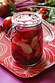 Pickled tomatoes and onions in a preserving jar