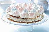 Layered tart with pastel-coloured meringue