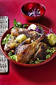 Roast goose legs with red cabbage and herbs