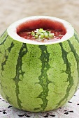 Cold melon and cucumber soup in hollowed-out watermelon