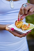 Woman eating deep-fried prawns