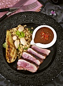 Duck breast with spicy sauce and pea and bean salad