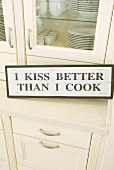 Kitchen cupboard with sign