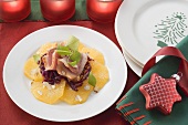 Smoked duck on red cabbage and orange slices for Christmas