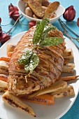 Bacon-wrapped turkey breast on roasted root vegetables