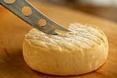Cutting washed-rind cheese with a cheese knife