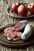 Salami, partly sliced, and apples
