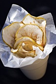 Apple crisps with paper in beaker