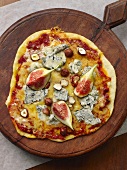 Pizza topped with Gorgonzola, figs and hazelnuts