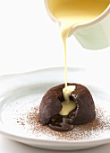 Pouring custard over chocolate pudding