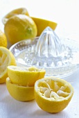 Squeezed lemon halves with lemon squeezer