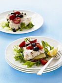 Fish fillet with tomatoes, olives and rocket