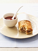 Sausage roll with tomato sauce