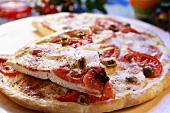 Tomato and mozzarella pizza with olives