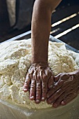 Making ricotta: pressing the cheese into a mould