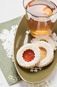 Linzer biscuits and glass of orange punch
