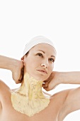 Woman with facial mask on neck and upper chest