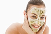 Young woman with herbal facial mask