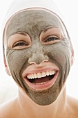 Woman with healing clay facial mask