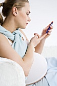 Pregnant woman testing her blood sugar