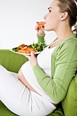 Pregnant woman eating vegetables