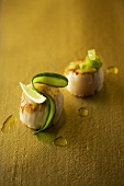 Fried scallops garnished with lime and cucumber