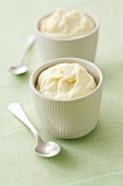 Two pots of mayonnaise with spoons