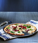 Ham and cheese pizza with basil
