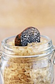 Black truffle and rice in storage jar