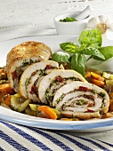 Mediterranean roast turkey roll on vegetables