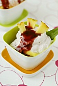 Pineapple with blackberry sauce and high-fat quark