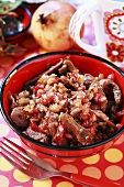 Duck goulash with pomegranate seeds