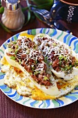 Stuffed pointed peppers on fried eggs