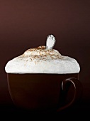 Cup of cappuccino with milk foam and spoon