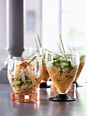Different seafood salads with cucumber in glasses